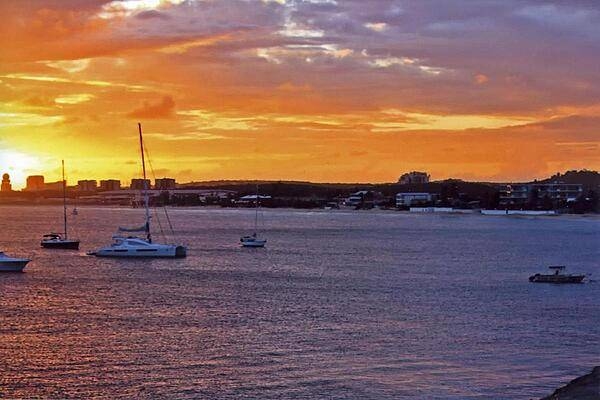 Princess Juliana International Airport at sunset as seen from across Simpson Bay Lagoon. The airport serves both the Dutch and French halves of the island.