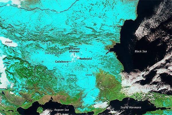 A wintertime false-color image shows most of Bulgaria covered in snow (light blue). The Danube River, which makes up much of the northern border of the country, snakes across the top of the photo. Clouds appear white as do exhaust plumes from power plants at Galabovo and Radetski. Image courtesy of NASA.