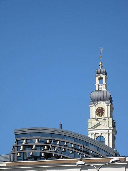 The bells in the forground were originally cast in the 13th century, but were remounted on the roof of the Riga City Council (Town Hall) building in the late 20th century. The modern carillon forms a striking contrast to the Town Hall&apos;s 18th century clock tower. The bells chime every hour on the hour.