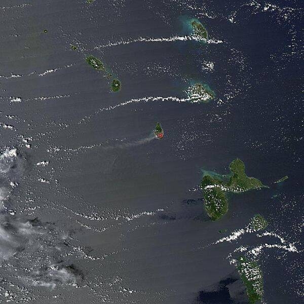 The Soufriere Hills Volcano on the island of Montserrat produced a plume of volcanic ash and/or steam on 1 October 2006, part of a continuing pattern of intermittent eruptions. In this image, the island of Montserrat shows an area outlined in red - the thermal hotspot. The plume of volcanic ash blows westward over the Caribbean Sea, gradually dissipating as it moves away. No recorded eruptions of the volcano occurred before 1995, but since then, volcanic ash emissions have posed recurring health hazards for Montserrat&apos;s residents. Photo courtesy of NASA.