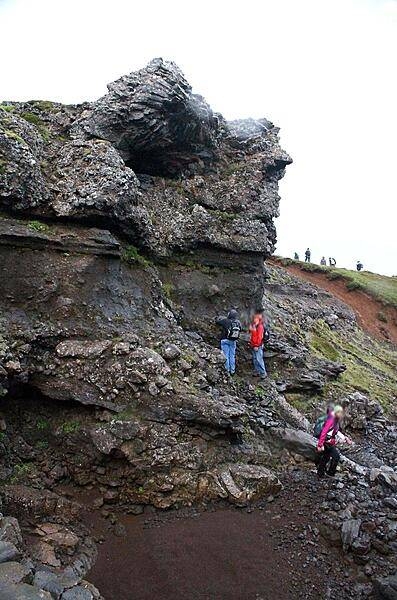 A dike (volcanic feeder tube) merging into layered strata in Thingvellir National Park.