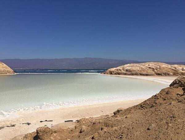 Lake Assal is a crater lake at the top of the Great Rift Valley, some 120 km west of Djibouti city. A saline lake, it lies 155 m below sea level in the Afar Triangle. It is the lowest depression on the African continent and is one the world's largest salt reserves.