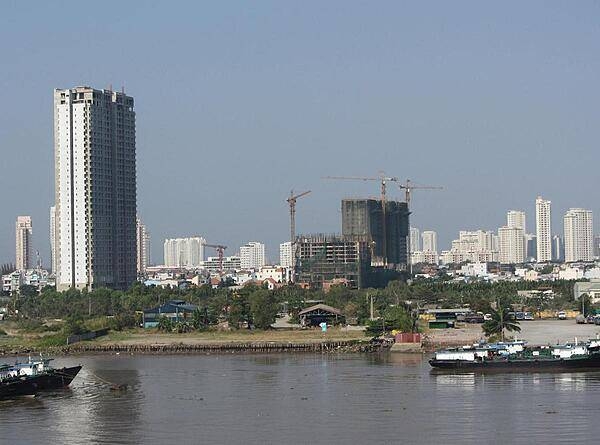 View of Ho Chi Minh City (aka Saigon) from the Saigon River. Saigon is Vietnam&apos;s major port and, with 8 million inhabitants, its largest city. It was called Saigon until 1975 when it was renamed Ho Chi Minh City following its capture by North Vietnamese communist forces. Although the city&apos;s commercial core is officially called Saigon, the entire city is widely referred to as Saigon even in the North. The city was architecturally influenced by the French during their colonial occupation of Vietnam. Numerous classical Western-style building in the city reflect this, so much so that Saigon was referred to as &quot;The Pearl of the Far East&quot; or &quot;Paris in the Orient.&quot; In more recent years, a building boom has transformed the skyline of the city.