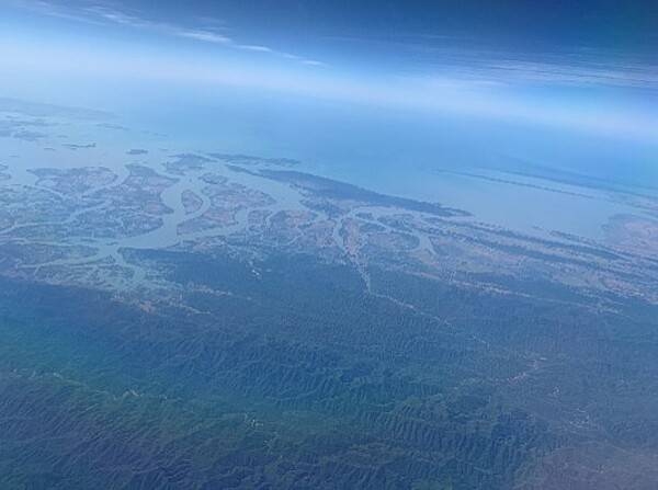 Aerial view of the Ganges River Delta formed by the Brahmaputra and the Ganges Rivers. Also known as the Ganges-Brahmaputra-Meghna (GBM) River Basin, the riverine confluence forms one of the largest river systems in the world. At the Bay of Bengal, the mouth forms the Ganges River Delta, the largest river delta in the world. The Ganges (Ganga) River and its surrounding watershed supports one of the most fertile and densely populated regions on the planet.