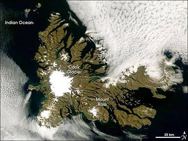 A rare break in the clouds allowed a satellite a chance to capture this photo-like image of the Kerguelen Islands. Located in the southern Indian Ocean roughly midway between Africa, Australia, and Antarctica, the Kerguelen Islands experience a fierce climate, with incessant, howling winds and rain or snow nearly every day. At a latitude of about 49 degrees south, the islands lie in the path of the &quot;Furious Fifties,&quot; a belt of westerly winds that whip around the Southern Hemisphere, mostly unimpeded by land.

The islands were formed over millions of years by a series of lava flows. The perimeter of the large island is carved by fjords, and the rocky landscape is very sparsely vegetated with grasses, mosses, and a plant in the cabbage family. Glaciers are scattered across the island. The largest is Cook Glacier, in the west. The highest point on the island is Mount Ross, which has an elevation of 1,850 m; it is also thought to be the youngest volcanic peak on the island. In a handful of fjords, the water appears greenish. The color is probably due to very fine sediment ground down by the enormous friction the glaciers generate as they scrape over the land. Rivers and streams flush this sediment out to the coast.

Despite the challenging climate, several animals and birds make their homes at Kerguelen or use it as a stopping over point in their migrations or during breeding. Among the wildlife on the Kerguelen Islands are several species of penguins, elephant and fur seals, and dozens of species of birds, including terns and albatrosses. The sea makes this &quot;wildlife sanctuary&quot; possible; the islands are located along the Antarctic Convergence Zone, where the icy waters of the Southern Ocean meet the warmer waters of the Indian Ocean. The waters in this mixing area are very rich in nutrients, which support ocean plants (phytoplankton) that are the foundation of the ocean food web. Photo courtesy of NASA.