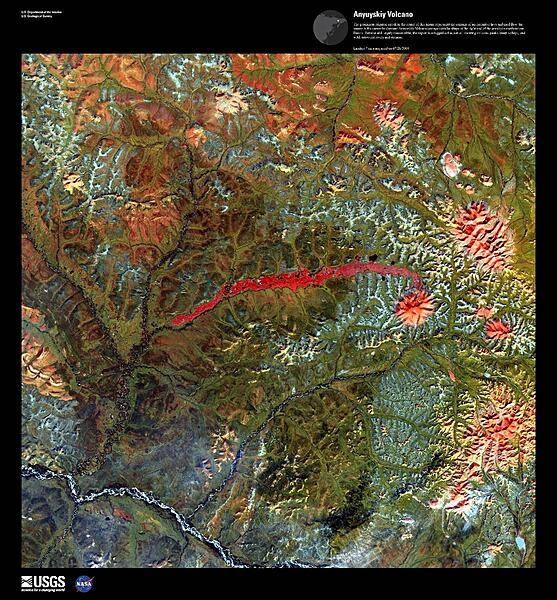 The prominent crimson streak in the center of this false-color satellite image represents the remains of a 50 km (31 mi) lahar (volcanic mudflow) that cut a strip of barren rock through rich vegetation surrounding the Anyuyskiy Volcano. The currently dormant volcano is the orange circular shape at the right end of the streak. Remote and largely inaccessible, the Kamchatka Peninsula is a rugged collection of towering volcanic peaks, steep valleys, active geysers, and wild, snow-fed rivers and streams. This volcano is part of the UNESCO World Heritage Site &quot;Volcanoes of Kamchatka.&quot; For other active volcanoes in Russia, see the Natural hazards-volcanism subfield in the Geography section. Image courtesy of USGS.