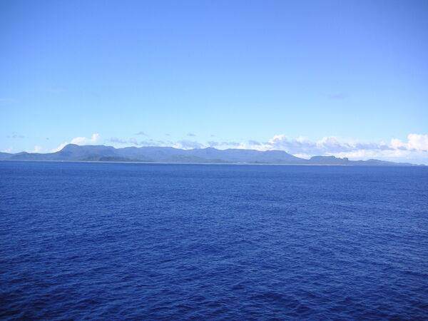 A view of the ocean approach to Pohnpei Island and the high volcanic topography of the island. To the right you can make out Paipalap Peak (Sokehs Rock) which overlooks Pohnpei harbor.