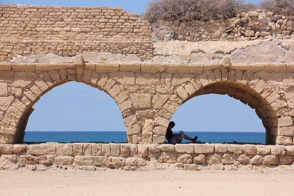 Present-day Caesarea is located midway between Tel Aviv and Haifa on the coastal plain of the Mediterranean Sea. The ancient city, known as Caesarea Maritima, was built by Herod the Great about 25–13 B.C. as a major port. With no reliable source of fresh water, Herod commissioned a system of aqueducts (surviving section shown) to supply water from the springs of nearby Mount Carmel. With additions and repairs, the aqueducts delivered water for 1200 years, until canals were built. Today, Caesarea Maritima is a national park of the ancient city’s ruins, and one of Israel’s tourist attractions.