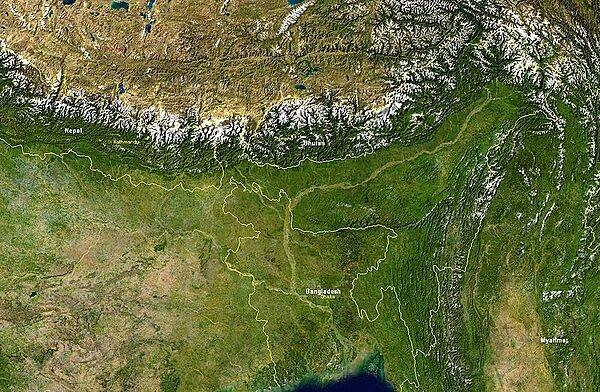 Satellite image showing Bangladesh and nearby countries. Bangladesh itself is bordered by India on its east, north, and west sides, and by Burma on the southeast. The snow-covered mountain chain is the Himalayas; to their north lies the Tibetan Plateau. Image courtesy of NASA.