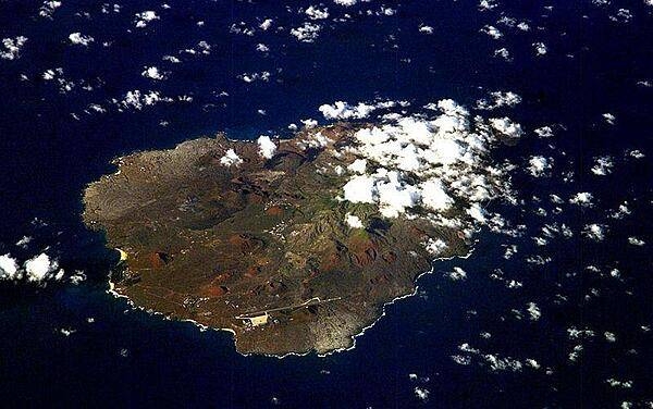 An oblique view of rugged Ascension Island, which is is barren in many places and has no indigenous human population. Instead the residents of the island are there because of Ascension's main industry: communications. The island has a long history as a communications hub for telephone and radio communications and as a base for satellite tracking stations, including a NASA station built in the 1960s that no longer operates. The European Space Agency operates a tracking station for its Ariane spacecraft on the eastern side of the island.
Ascension Island is one of the most important breeding grounds for seabirds in the tropical Atlantic Ocean. The population of seabirds has been under threat since the first humans sailed up to the island in the 1500s. The ships accidentally introduced black rats, which overran the island, until cats were introduced to curb the rat population. The feral cats have decimated the bird populations, and in fact, are probably responsible for the extinction of two of the islands native land birds. A restoration project is underway to control the cat population and revive the seabirds. Image courtesy of NASA.