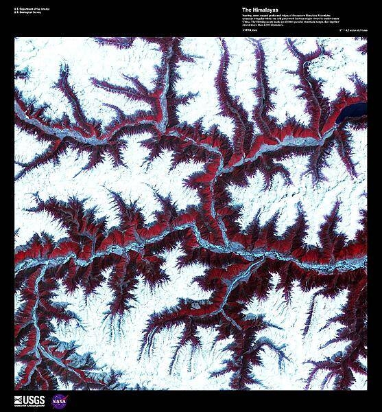 Soaring, snow-capped peaks and ridges of the eastern Himalaya Mountains create an irregular white-on-red patchwork between major rivers in southwestern China in this enhanced satellite image. The Himalayas are made up of three parallel mountain ranges that together extend more than 2,900 km (1,800 mi) and are the youngest mountain range on the planet. Some of the world&apos;s major rivers rise in these mountains and their combined drainage basin is home to almost half of the world&apos;s entire population. Image courtesy of USGS.