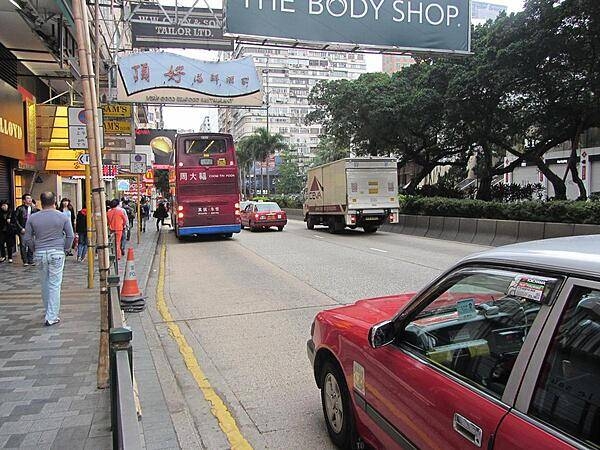 A street scene on Nathan Road in downtown Kowloon in Hong Kong. Double-decker buses are popular.