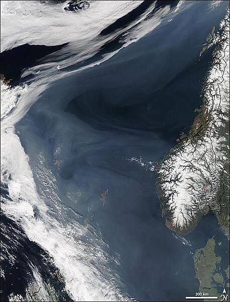 Grayish white over the deep blue Norwegian Sea, a thick cloud of smoke drifts north off the western coast of Norway in this image, taken on 7 May 2006, by NASA&apos;s Aqua satellite. The smoke is coming from hundreds of fires burning in western Russia, most of which are probably agricultural fires. By the time this image was taken, smoke had lingered over the Norwegian Sea for more than a week as the fires continued to burn. In this image, hazy skies extend from Denmark, lower right, west to Iceland, upper left. The densest of the smoke hangs over the Shetland Islands (lower center) and the Faroe Islands (left center). The northern shores of Great Britain are in the lower left corner of the image. Red dots mark the locations of scattered burning fires in Norway. Photo courtesy of NASA.