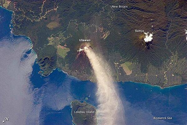 Numerous volcanoes contribute to the landmass of the island of New Britain, the largest in the Bismarck Archipelago of Papua New Guinea. One of the most active of these volcanoes - Ulawun - is also the tallest, with a summit elevation of 2,334 m (7,657 ft).

This astronaut photograph shows a plume of white steam and ash extending from the summit crater of the stratovolcano towards the northwest. The plume begins to broaden as it passes the southwestern coast of Lolobau Island, approximately 23 km downwind. Note that north is towards the lower left.

Ulawun is also known as &quot;the Father,&quot; with the Bamus volcano to the southwest also known as &quot;the South Son.&quot; The summit of Bamus is obscured by white cumulus clouds (not of volcanic origin) in this image. While Ulawun has been active since at least 1700, the most recent activity at Bamus occurred in the late 19th century. A large region of ocean surface highlighted by sunglint - sunlight reflecting off the water surface - is visible to the north-northeast of Ulawun. Photo courtesy of NASA.