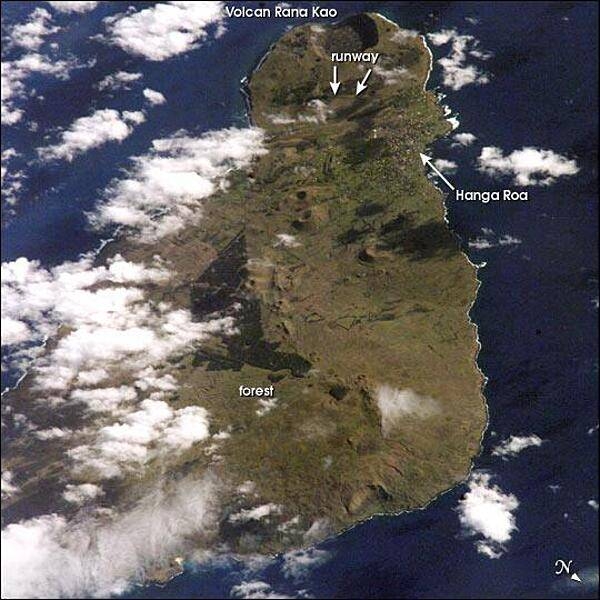 View of Easter Island from space. The island is one of the most remote locations on Earth, being more than 3,200 km (2,000 mi) from the closest populations on Tahiti or Chile. The island is perhaps most famous for the giant stone monoliths, known as moai, that have been placed along the coastline. Archaeologists believe the island was discovered and colonized by Polynesians sometime between A.D. 400 and 700. Subsequently, a unique culture developed. The human population grew to levels that could not be sustained by the island. A civil war resulted, and the island&apos;s deforestation and ecosystem collapse was nearly complete. Today, a new forest (primarily eucalyptus) has been established in the center of the island (dark green). Less than 25 km (15 mi) long, the geography of the island is dominated by volcanic landforms, including the large crater Rana Kao at the southwest end of the island and a line of cinder cones that stretch north from the central mountain. A final feature (difficult to see) is the very long runway (Chile&apos;s longest) near Rana Kao, which served (but was never used) as an emergency landing site for the Space Shuttle. Image courtesy of NASA.