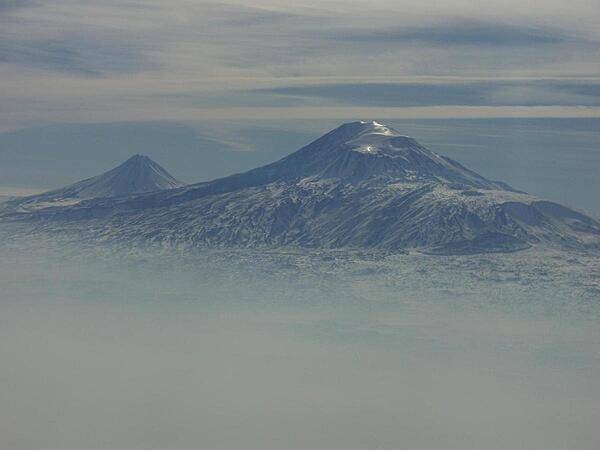 A view of Mount Ararat in western Turkey through the fog. The highest of its two peaks, Greater Ararat, is the tallest mountain in Turkey at 5,166 m (16,949 ft). Although located some 32 km (20 mi) from the Armenian border, the dormant volcano dominates the skyline of Yerevan, Armenia's capital. This photo was snapped after take off from the Yerevan airport.