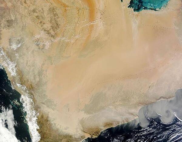 A thick dust cloud travels southward from Saudi Arabia's Rub al Khali sand sea towards the edge of the Arabian Peninsula. This natural-color satellite image shows the dense part of the cloud approaching Yemen (lower left) and translucent swirls of dust over the Arabian Sea.Lines of small clouds cling to the margins of the dust plumes south of Oman (lower right). These clouds may result from the same weather front that kicked up high winds and stirred the dust storm. This region is one of the world's most prolific dust-producing areas, thanks in part to the presence of the sand sea. The Rub al Khali holds about half as much sand as the Sahara Desert. Image courtesy of NASA.