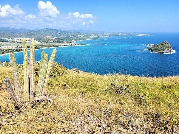 A view looking north from the southern tip of Saint Lucia along the southeastern coast of the island. The islands to the right make up the Maria Islands Nature Preserve.