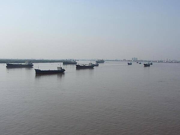 A small flotilla of boats on the Saigon River, which serves as the main water source for the port of Saigon.