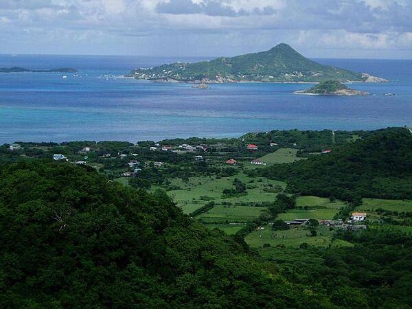 Photo taken from the island of Carriacau, part of Grenada. The island visible on the horizon is Petit Martinique, also part of Grenadan territory.