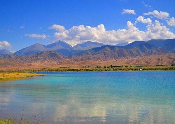 Issyk-Kul (Warm Lake) is an endorheic lake - it lacks any outflow to another body of water - in the Northern Tian Shan mountains in Eastern Kyrgyzstan. The lake is globally significant for its biodiversity of plant, animal, and bird species. Issyk-Kul Lake is 182 km (113 mi) long, up to 60 km (37 mi) wide, and its area is 6,236 sq km (2,408 sq mi).