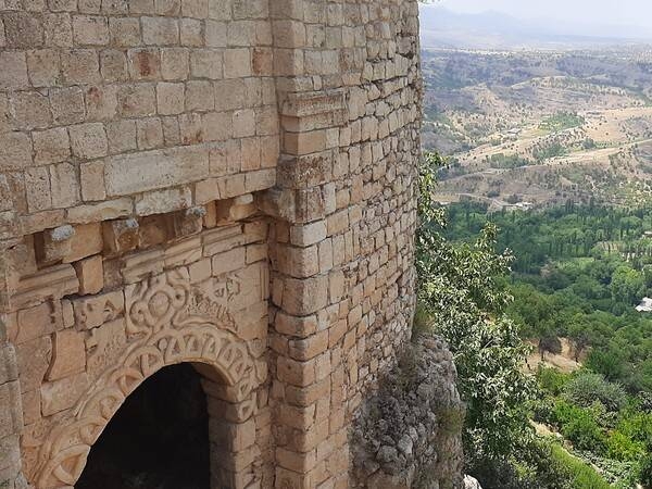 Amadiya or Amedi is a town located on a mesa in the Kurdistan Region of northern Iraq. The Bahdinan Gate is the entrance to the citadel of Al Amadiya, which was built for the defense of Amadiya and as part of a trading route between Amadiya, Mosul, Sinjar, and Baghdad. The gate is 4 m (13 ft) wide with a large winding stone staircase leading to it and has carvings of unknown people, the sun, and a cord with multiple loops.