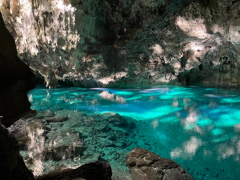 Parque Nacional los Tres Ojos (National Park of the Three Eyes) is a nature reserve and open-air limestone cave system in Santo Domingo, Dominican Republic. Water filters down from the surface and collects in several pools at the base of the sinkhole. In the early morning, the sun is low enough to reach the clear, mineral-rich waters, providing a stunning reward for early risers.