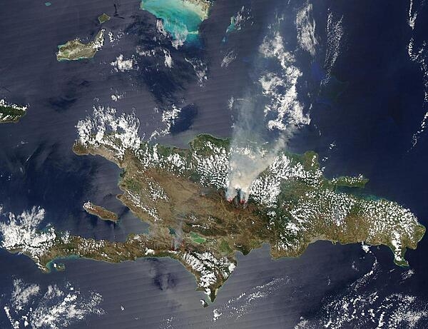 Smoke pours from fires burning in the Dominican Republic in this Aqua satellite image, taken on 18 March 2005. Numerous fires, marked with red squares, dot the island, but the most intense are burning in the center of the island. The majority of the fires are probably agricultural fires, set to prepare land for planting. The largest fires, however, may be uncontrolled. These fires appear to be burning in the Cordillera Central, the mountains that arc across the center of the island of Hispaniola, near Pico Duarte, the highest point in the West Indies. Pico Duarte is covered with pine forests at its higher elevations and savannah grasslands at lower elevations. Because the smoke in the heights is thicker than other fires on the island, the large fires may be burning in the high pine forests. The dry season usually runs from December to May for most of the island; March is typically the driest month in the Dominican Republic. Photo courtesy of NASA.