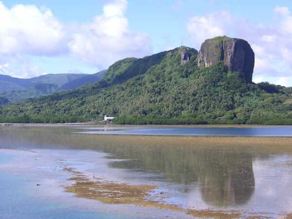 A view of Paipalap Peak (Sokehs Rock) overlooking Pohnpei harbor in Micronesia. The rock, rising over 186 m (610 ft), is a basalt volcanic plug. This prominent feature is sometimes referred to as the Diamond Head of Micronesia, since it resembles Diamond Head peak on Oahu in the Hawaiian Islands.