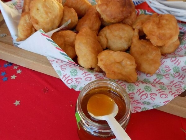 Priganice are fritters or flat doughnuts served with honey, cheese, or jam.