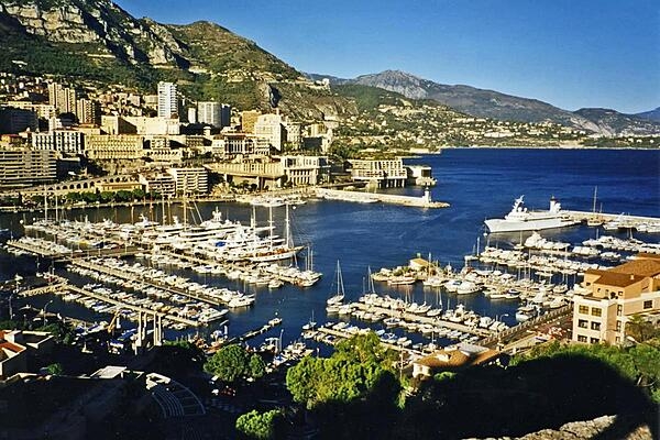 A view of Monte Carlo with the Port of Monaco in the foreground. The ship on the right is that of the prince of Monaco.