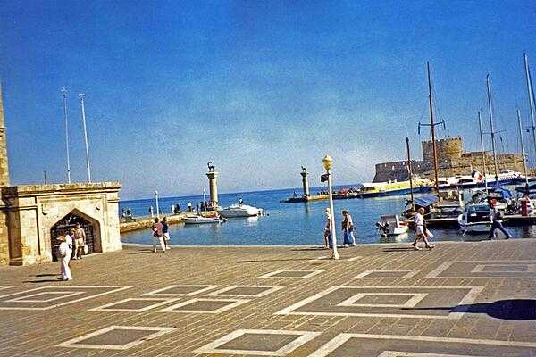 Mandraki Harbor at Rhodes, Greece, once the site of a massive statue to the Greek sun god, Helios. Standing some 30 m (100 ft) high and erected in the third century B.C., it became known as the Colossus of Rhodes and was considered one of the Seven Wonders of the Ancient World.
