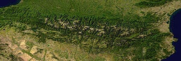 Composite satellite image of the Pyrenees. Andorra lies about one-third of the way into the range from the east (right). The country is composed primarily of rugged mountains, but these are dissected by three narrow valleys where most of the populace lives. Image courtesy of NASA.