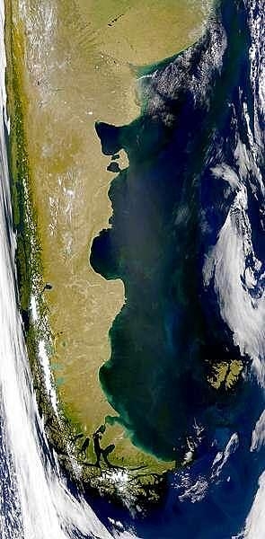Summertime (January) satellite image of the southern cone of South America showing green vegetation on the Andes Mountains of south Chile, the Patagonian plains of south Argentina, and the Falkland Islands. The bright green areas are algal blooms. Photo courtesy of NASA.