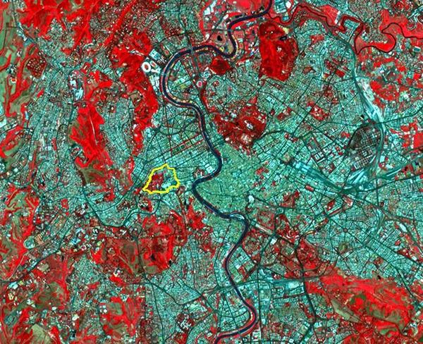 A false-color image of Rome shows the extent of Vatican City within the larger urban setting and shows just how small an entity it is (only .44 sq km). Red represents vegetation; the black winding river that runs from top to bottom through the middle of the scene is the Tiber. Image courtesy of NASA.