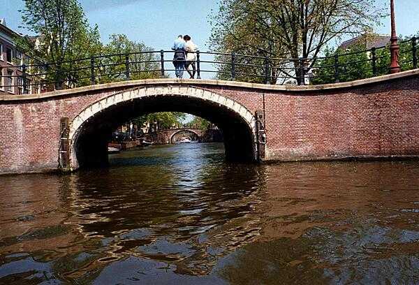 A series of bridges spanning an Amsterdam canal in the Netherlands.