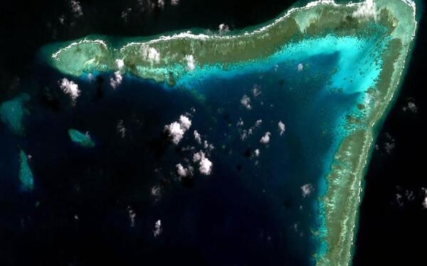 A 2011 view from space of Whitson Reef in the Spratly Islands. Whitson is the largest reef of the Union Banks and lies at their northeastern most extreme limit.  The reef is claimed by China, the Philippines, and Vietnam. Image courtesy of NASA.