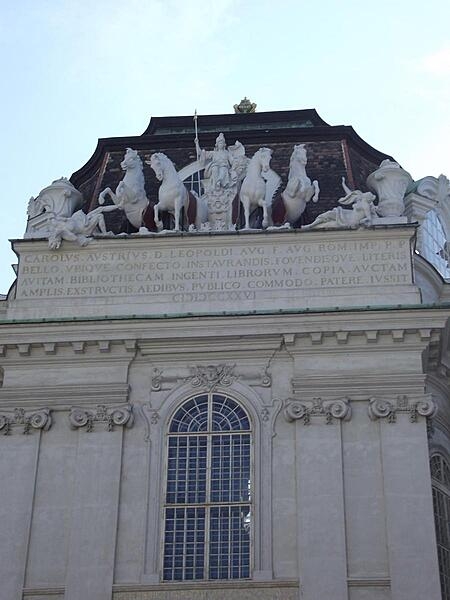 Sculptures and inscription over the entrance to the Prunksaal (Grand Hall) of the Austrian National Library in Vienna.