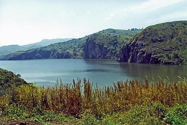 Lake Nyos is a crater lake on the flank of an inactive volcano. Magma beneath the lake leaks carbon dioxide into the waters. In 1986, the lake emitted a large cloud of carbon dioxide that suffocated nearly 1,800 people and some 3,500 livestock in nearby villages.