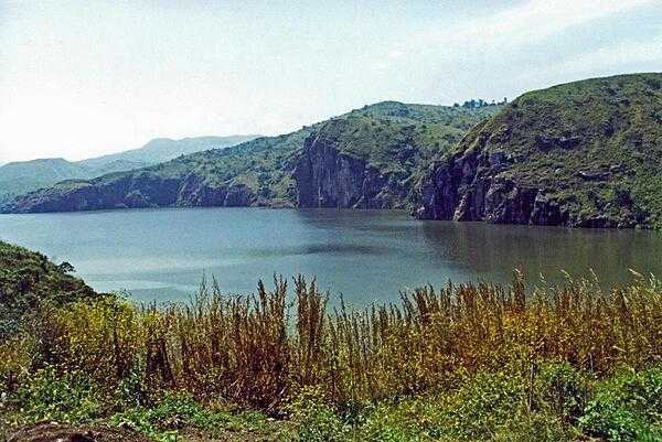 Lake Nyos is a crater lake on the flank of an inactive volcano. Magma beneath the lake leaks carbon dioxide into the waters. In 1986, the lake emitted a large cloud of carbon dioxide that suffocated nearly 1,800 people and some 3,500 livestock in nearby villages.