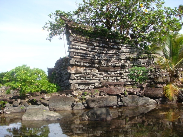 The Nan Madol ruins are on a coral reef in a lagoon on the tiny island of Temwen, next to the eastern shore of the island of Pohnpei in the Federated States of Micronesia. Carved basalt stones were carefully placed on top of each other in a crisscross pattern to form the walls of the 130 buildings. The heaviest of the basalt pillars weigh 45,000 kg (100,000 lbs) each.