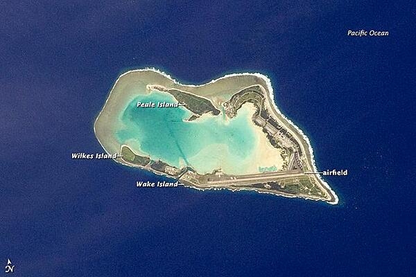 The atoll of Wake Island is composed of Wake Island proper and the smaller Peale and Wilkes Islands for a total land surface area of 6.5 sq km (2.5 sq mi). Like many atolls in the Pacific, the islands and associated reefs formed around a submerged volcano. The lagoon in the center of the islands marks the approximate location of the summit crater. Image courtesy of NASA.