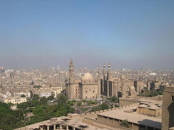 The Sultan Hassan and Ar-Rifai Mosques as seen from the Citadel with Cairo in the background. The Sultan Hassan Mosque and Madrasah (religious school) is a masterpiece of Mamluk architecture that was begun in 1356 and completed in 1363. It contains the burial chamber of the Sultan&apos;s two sons and is featured on the Egyptian hundred-pound note. The Ar-Rifai Mosque was built between 1869 and 1912. It houses the tomb of King Farouk, Egypt&apos;s last reigning monarch, and other members of the Egyptian royal family, as well as the tomb of the last shah of Iran.