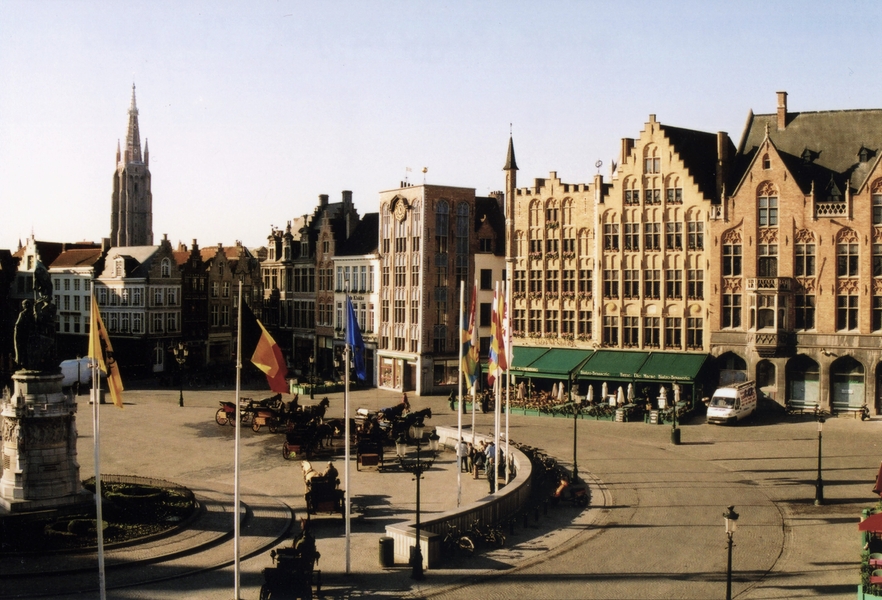The expansive Market Square in Bruges (Brugge), Belgium. The city is famous for its lace industry and canals. Market Square is the central gathering point for tourists and shops.