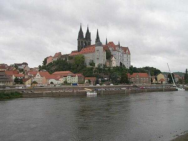 Albrechtsburg Castle and the Meissen Cathedral overlooking the city of Meissen, Germany, known as the "cradle of Saxony." The castle, designed in late Gothic style, was constructed in the 15th century as a residence. It is now a museum with murals illustrating the history of Saxony Meissen. The Gothic Meissen Cathedral, begun in 1260 on the same hill as the castle, is one of the smallest cathedrals in Europe.