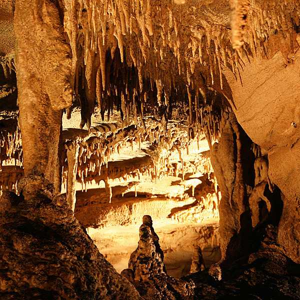 Stalactites and stalagmites made of travertine can be seen on the Frozen Niagara tour of Mammoth Cave in Kentucky. Travertine, or traveling stone, is made of limestone that has crystalized from dripping water. Image courtesy of the US National Park Service.