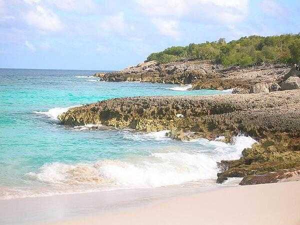 Anguilla, one of the Leeward Islands in the Caribbean, is composed of scrub-covered coral and limestone, which can be seen in this photograph of Limestone Bay. The island&apos;s many bays and pristine beaches draw visitors from around the world, making tourism Anguilla&apos;s main industry.