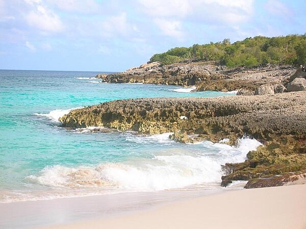 Anguilla, one of the Leeward Islands in the Caribbean, is composed of scrub-covered coral and limestone, which can be seen in this photograph of Limestone Bay. The island&apos;s many bays and pristine beaches draw visitors from around the world, making tourism Anguilla&apos;s main industry.
