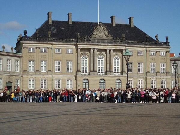 One of four identical rococo buildings making up the Amalienborg Palace in Copenhagen. The crowds gather to watch the changing of the guard ceremony.