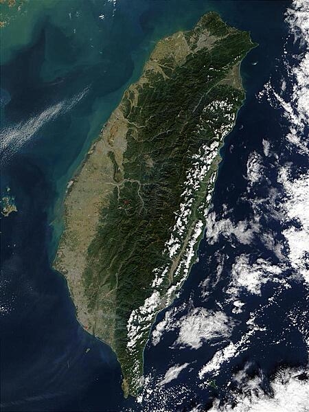 The island of Taiwan is mostly mountainous in the east, but gradually transitions to gently sloping plains in the west. At the northern tip of the island is Taiwan&apos;s capital city, Taipei, which appears as a large grayish patch surrounded by dark green. In this image, most of Taiwan&apos;s eastern coast is dotted with low clouds, with low and high clouds over the Pacific Ocean. The imaging satellite also detected three fires, which are marked in red. Photo courtesy of NASA.